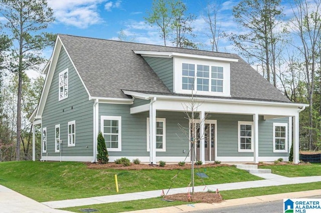 view of front of home with a porch and a front yard