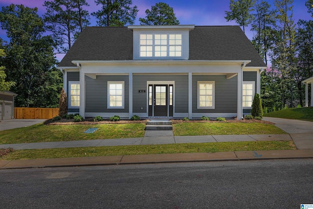 view of front of house featuring a lawn and covered porch