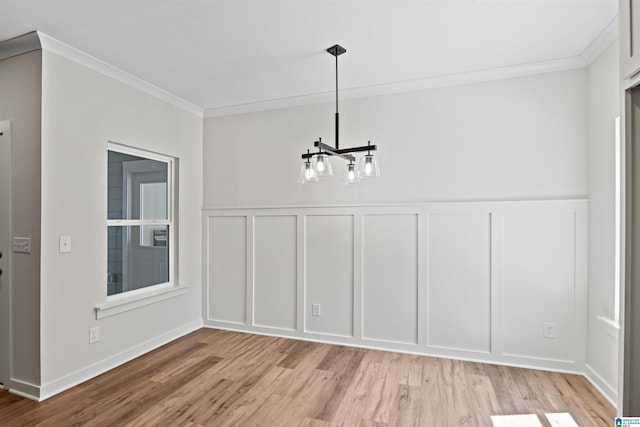 186 Barimore Blvd, Helena, AL 35080 - unfurnished dining area featuring a decorative wall, a chandelier, light wood-style flooring, crown molding, and a wainscoted wall