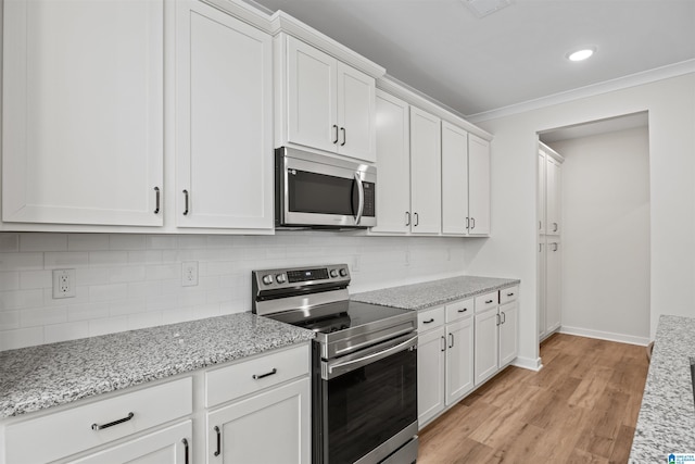186 Barimore Blvd, Helena, AL 35080 - kitchen featuring appliances with stainless steel finishes, white cabinets, light wood-style floors, decorative backsplash, and crown molding