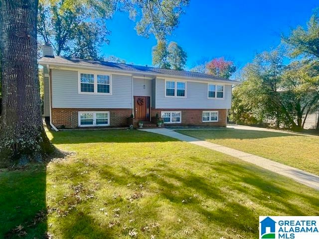 raised ranch with a front yard