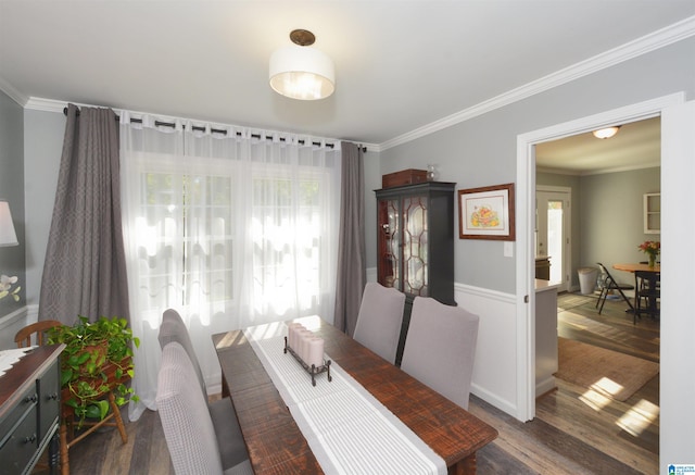 dining space featuring dark hardwood / wood-style floors and crown molding