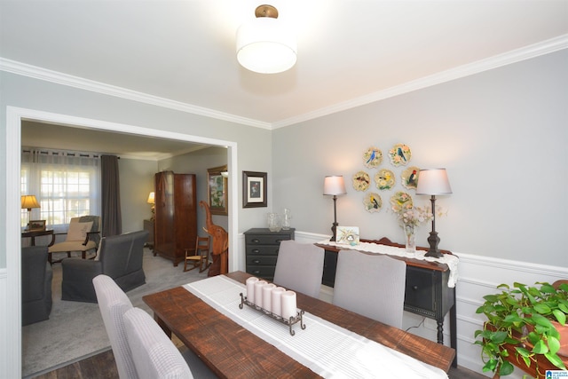 dining room featuring hardwood / wood-style flooring and ornamental molding