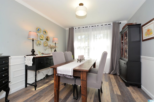 dining area with crown molding and dark wood-type flooring