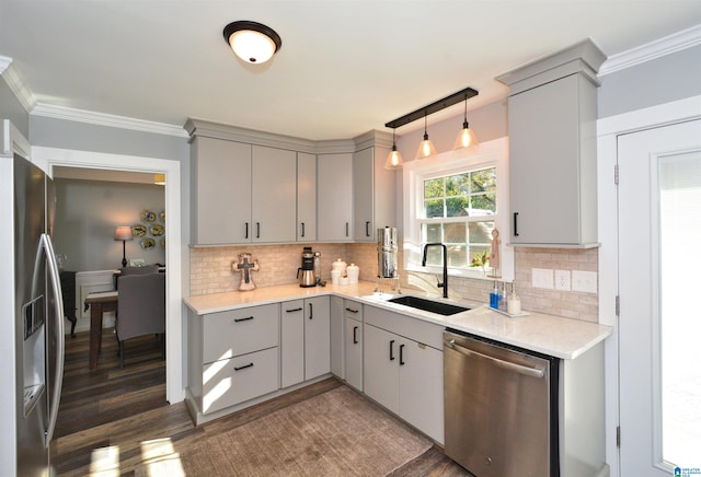 kitchen with appliances with stainless steel finishes, pendant lighting, and gray cabinetry