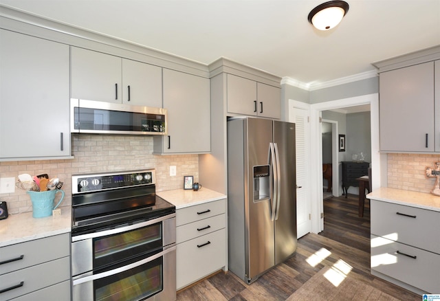 kitchen with stainless steel appliances, dark hardwood / wood-style floors, and gray cabinetry