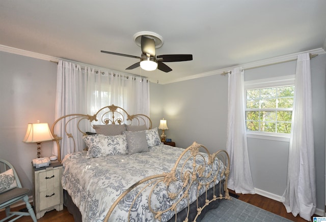 bedroom with ornamental molding, ceiling fan, and dark wood-type flooring