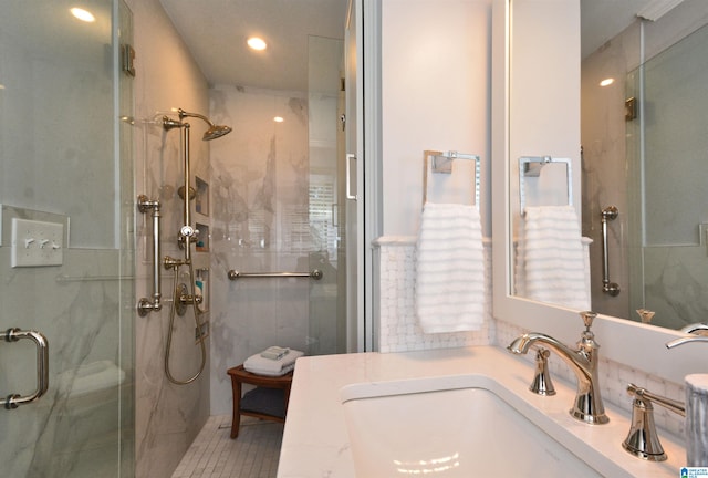 bathroom featuring tile patterned floors, vanity, an enclosed shower, and tile walls