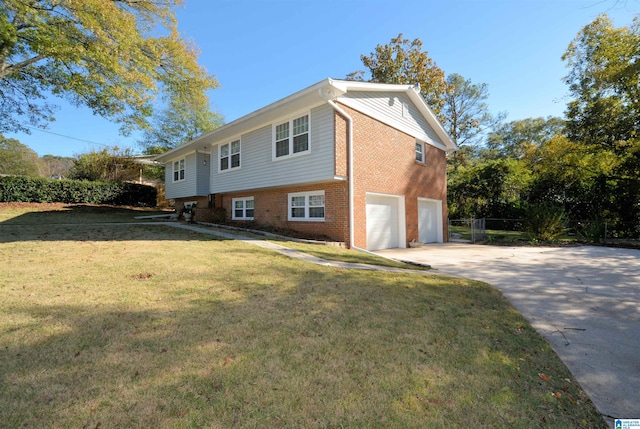 view of side of property with a yard and a garage