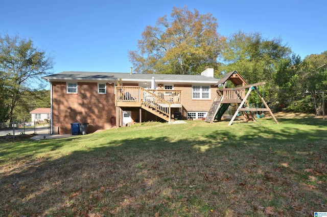 rear view of house featuring a deck and a yard