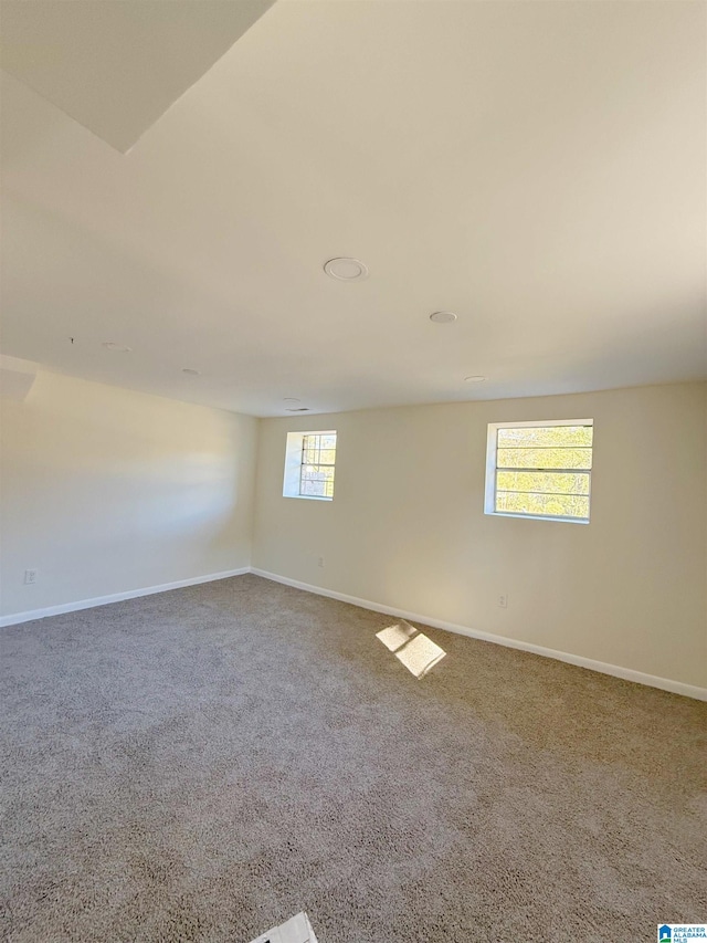 basement with carpet and a healthy amount of sunlight