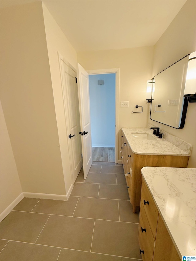 bathroom with tile patterned flooring and vanity