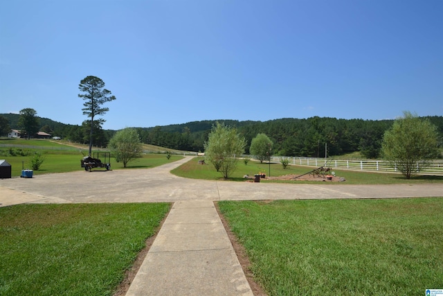 view of home's community featuring a rural view and a lawn