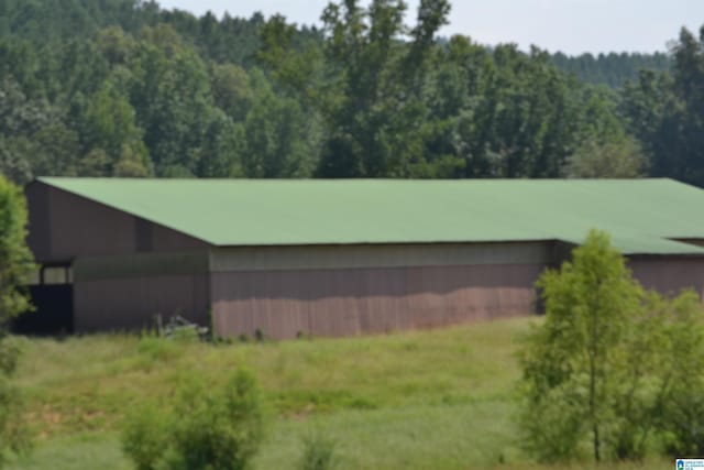 exterior space with an outbuilding and a lawn