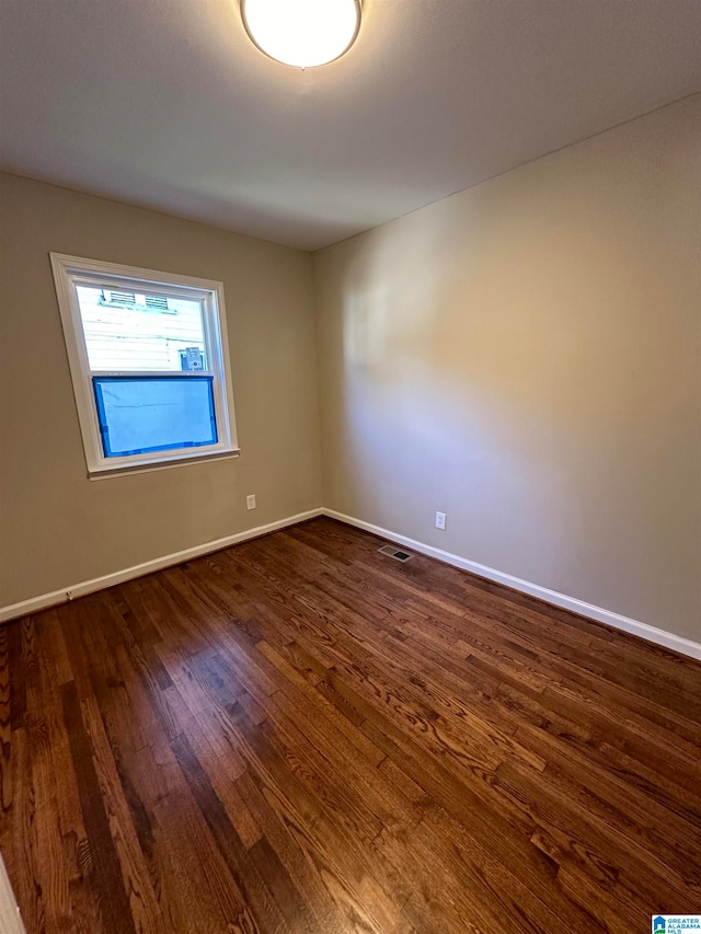 unfurnished room featuring dark hardwood / wood-style floors