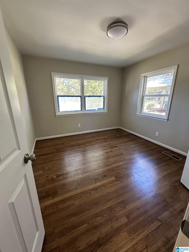 101 S 18th Ct, Birmingham, AL 35205 - unfurnished room featuring healthy amount of natural light, dark wood-style floors, and baseboards