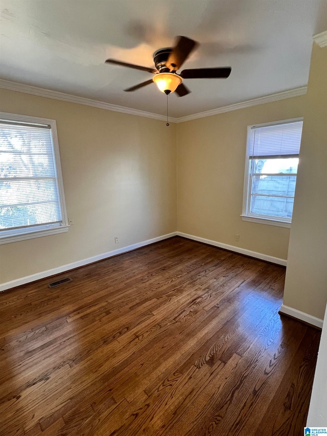 spare room featuring ceiling fan, crown molding, and dark hardwood / wood-style floors