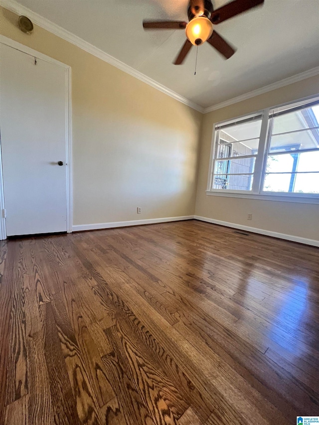 unfurnished room featuring dark hardwood / wood-style floors, ceiling fan, and crown molding