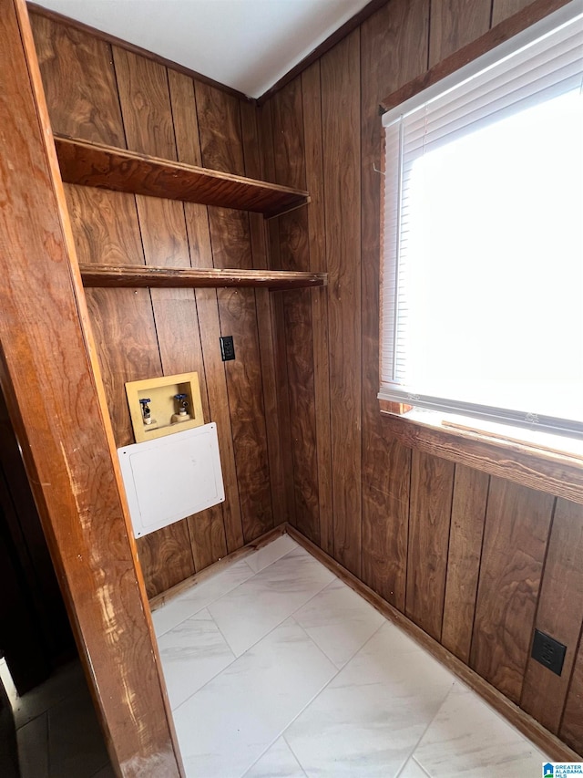 washroom featuring wooden walls and hookup for a washing machine