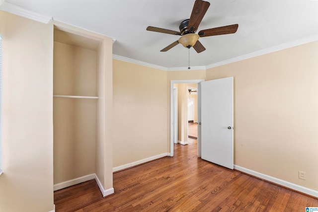 unfurnished bedroom with hardwood / wood-style flooring, ceiling fan, and crown molding