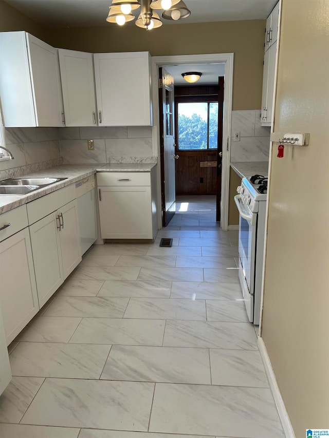 kitchen with white cabinets, sink, white appliances, and backsplash