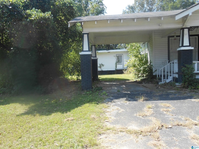 1387 Hueytown Rd, Hueytown, AL 35023 - view of grassy yard with asphalt driveway and an attached carport