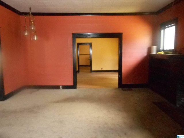 carpeted spare room featuring ornamental molding