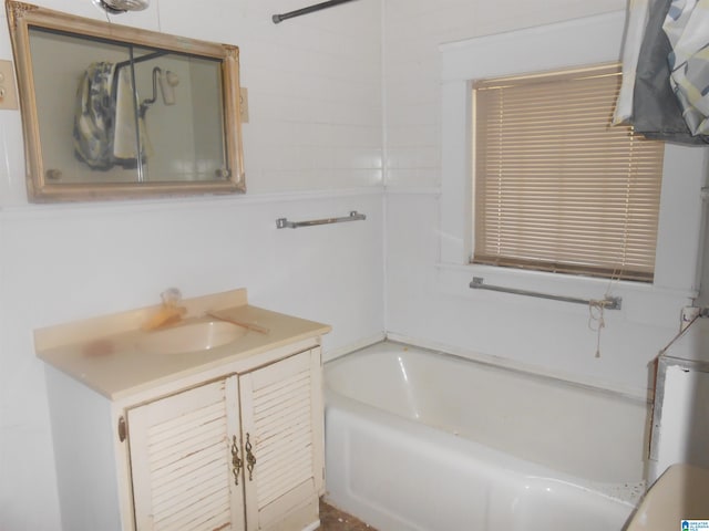 bathroom featuring vanity and a tub