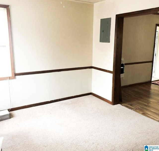 unfurnished room with hardwood / wood-style flooring and electric panel