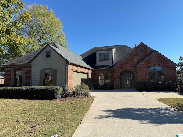 view of front of property with a front yard and a garage