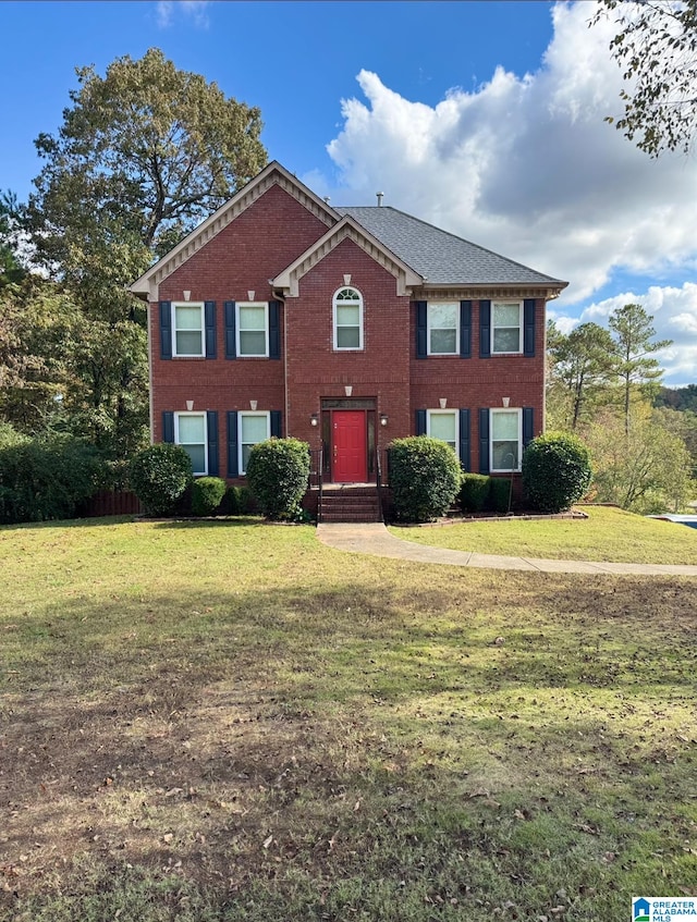 colonial home with a front lawn