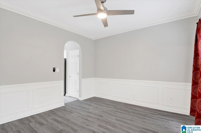 spare room with hardwood / wood-style flooring, ceiling fan, and ornamental molding