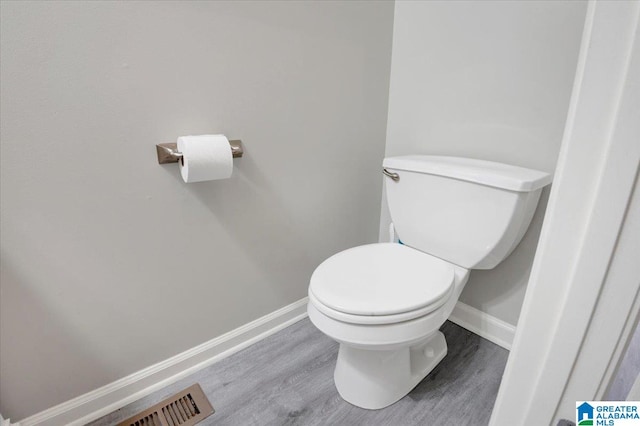 bathroom with wood-type flooring and toilet