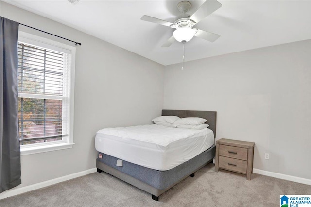 bedroom with ceiling fan and light colored carpet