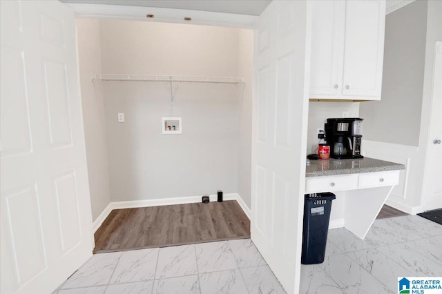 washroom featuring hookup for a washing machine and light hardwood / wood-style flooring