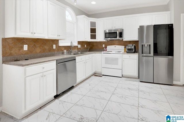 kitchen featuring white cabinets, ornamental molding, appliances with stainless steel finishes, and tasteful backsplash