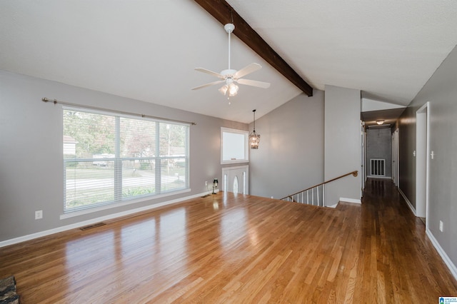 unfurnished living room with hardwood / wood-style flooring, vaulted ceiling with beams, and ceiling fan