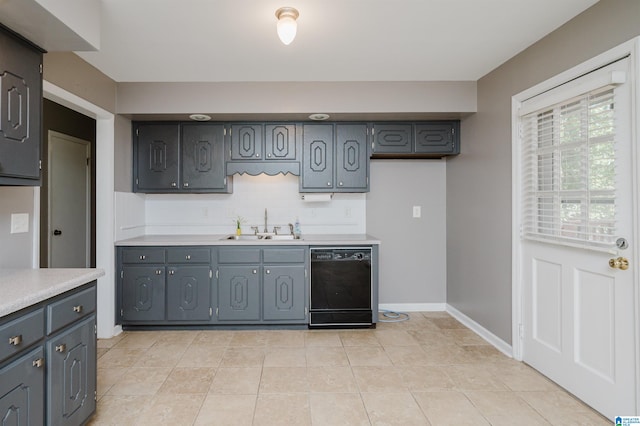 kitchen featuring gray cabinetry, sink, light tile patterned floors, and black dishwasher