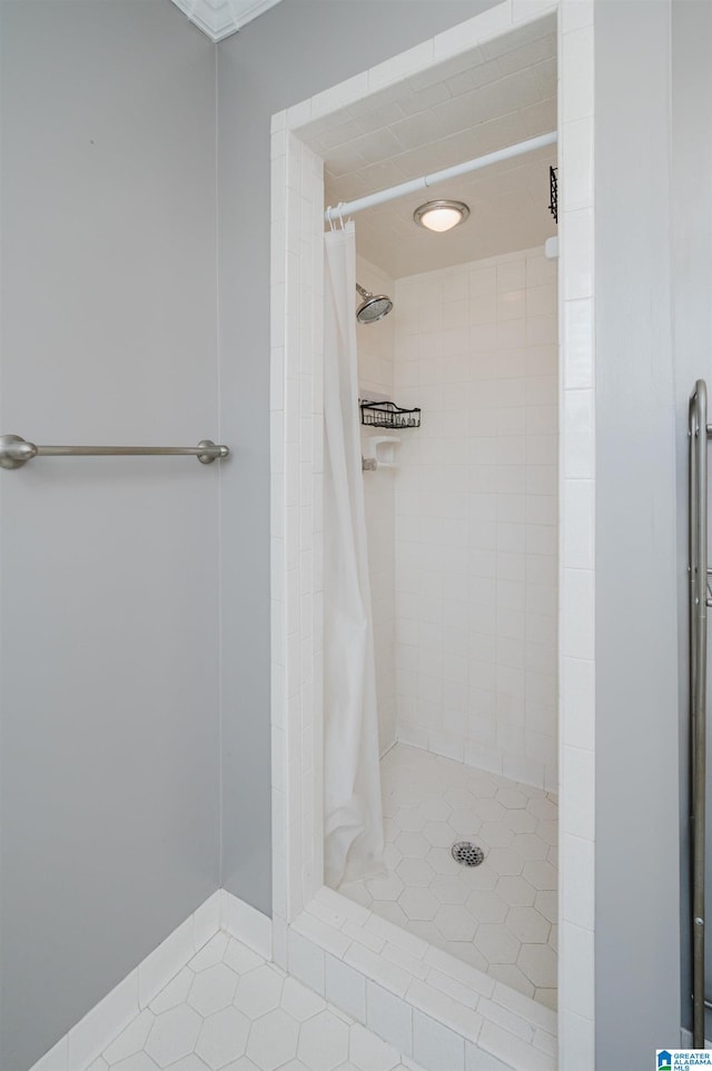 bathroom with tile patterned flooring and curtained shower