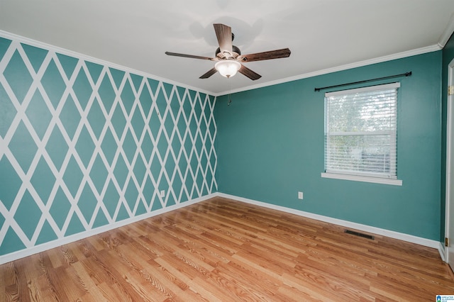 spare room with light wood-type flooring, ceiling fan, and ornamental molding