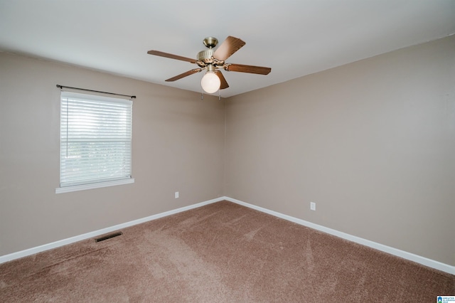 spare room featuring carpet and ceiling fan