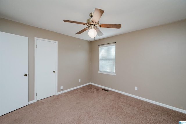 empty room with carpet and ceiling fan