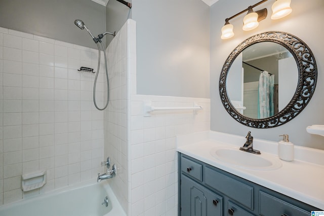 bathroom featuring vanity, shower / bath combo with shower curtain, and tile walls