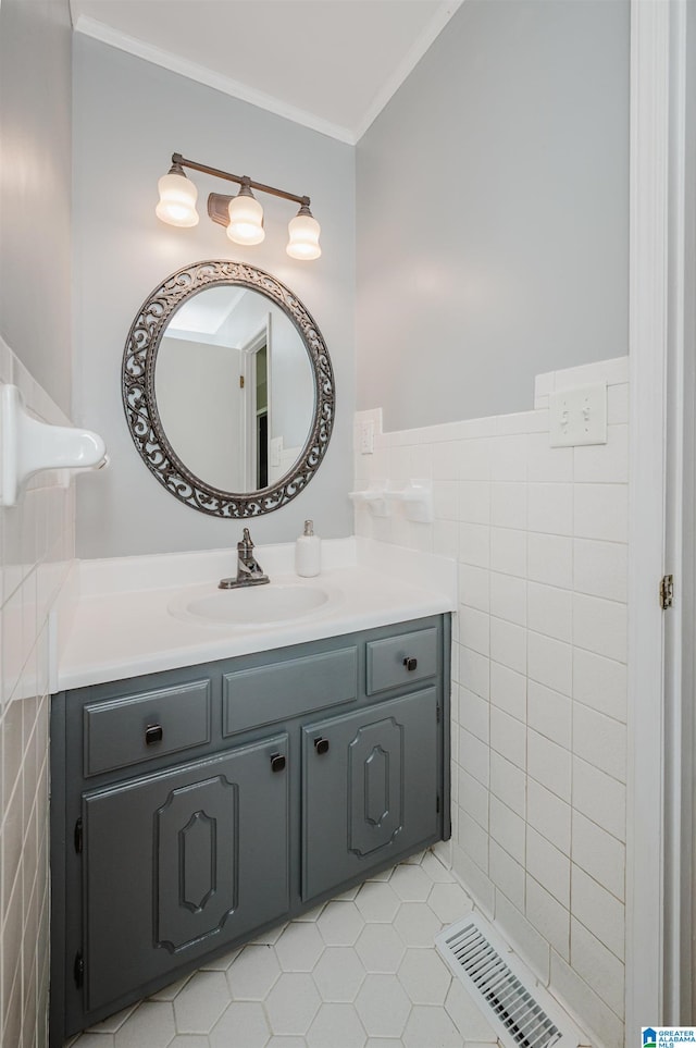 bathroom featuring tile patterned floors, vanity, ornamental molding, and tile walls