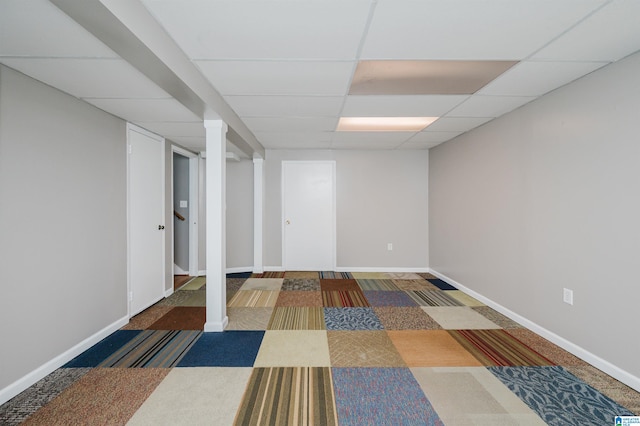 basement with carpet and a paneled ceiling