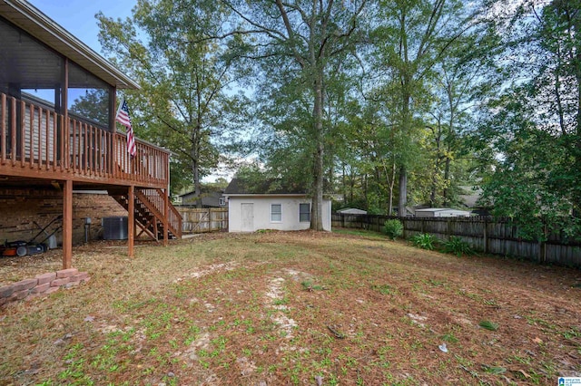 view of yard featuring a deck, an outdoor structure, and central air condition unit