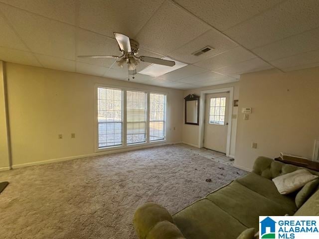 unfurnished living room with carpet floors, a paneled ceiling, and ceiling fan