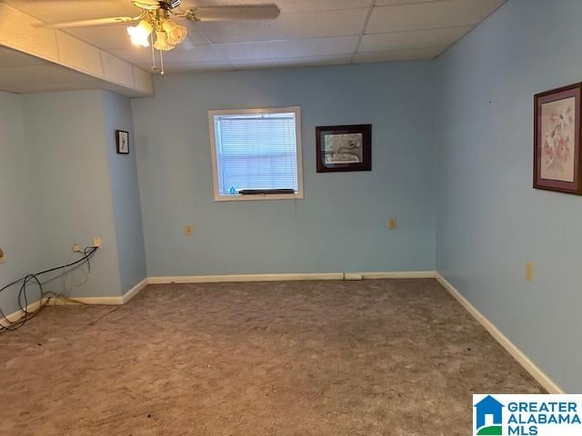 carpeted spare room featuring ceiling fan