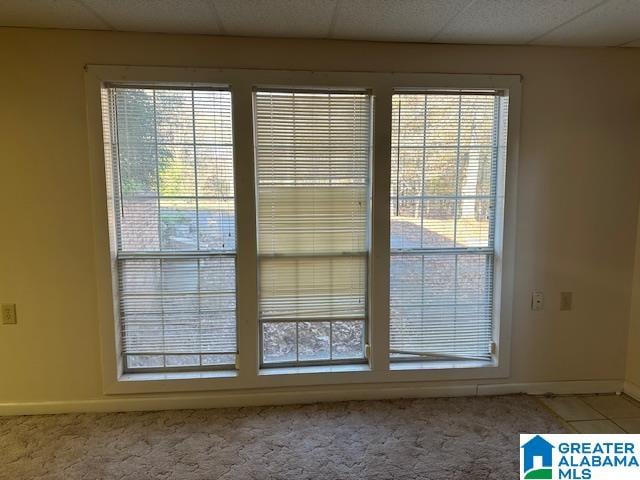 entryway featuring a paneled ceiling and carpet flooring