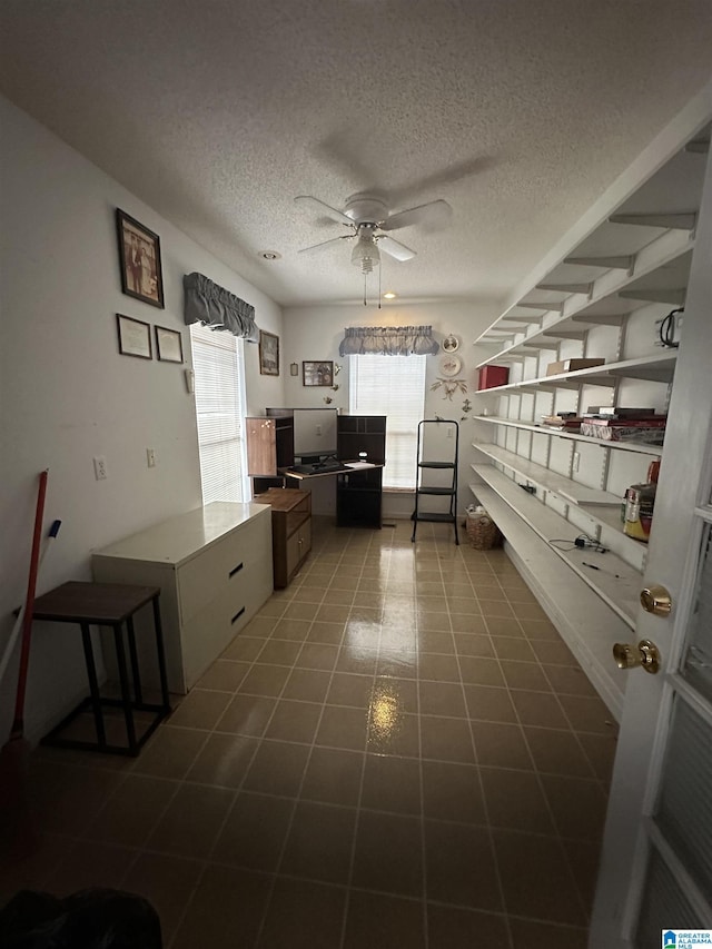 kitchen with ceiling fan and a textured ceiling